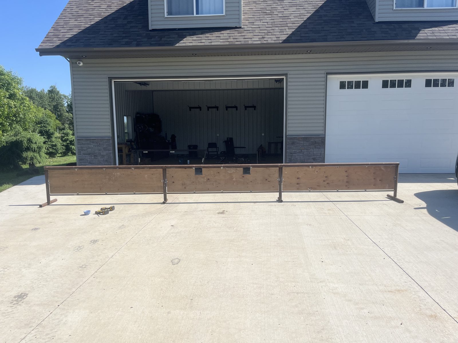 Long flat rail being fabricated in the shop driveway